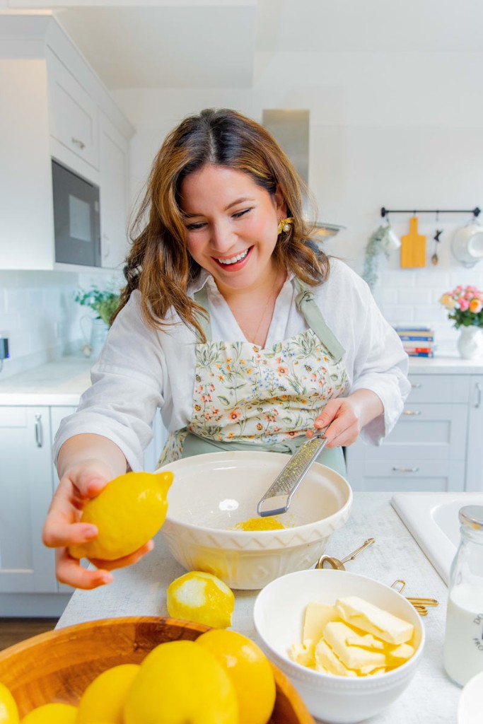 Laura Alejandra, founder of Abba Cakes, zesting a lemon in the kitchen
